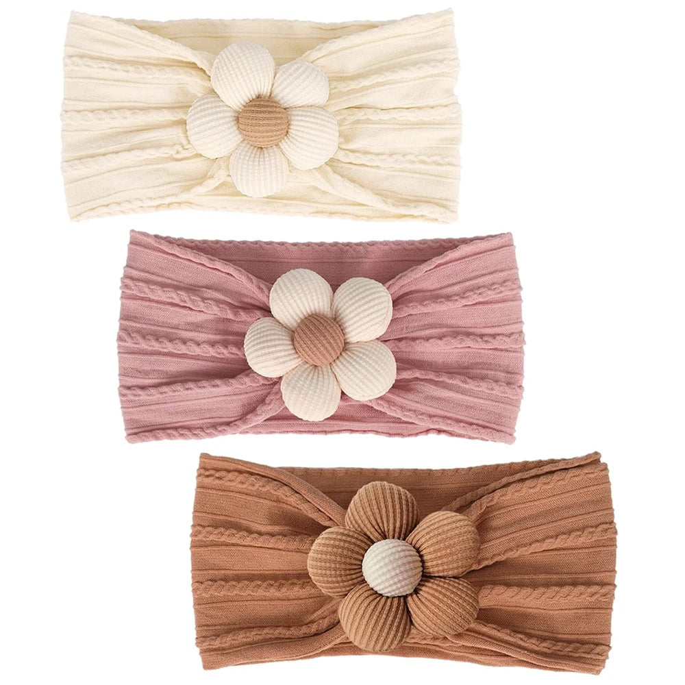 trio of baby hair accessories in buttercream, rosewood, and toasted pecan colors with textured flower centers