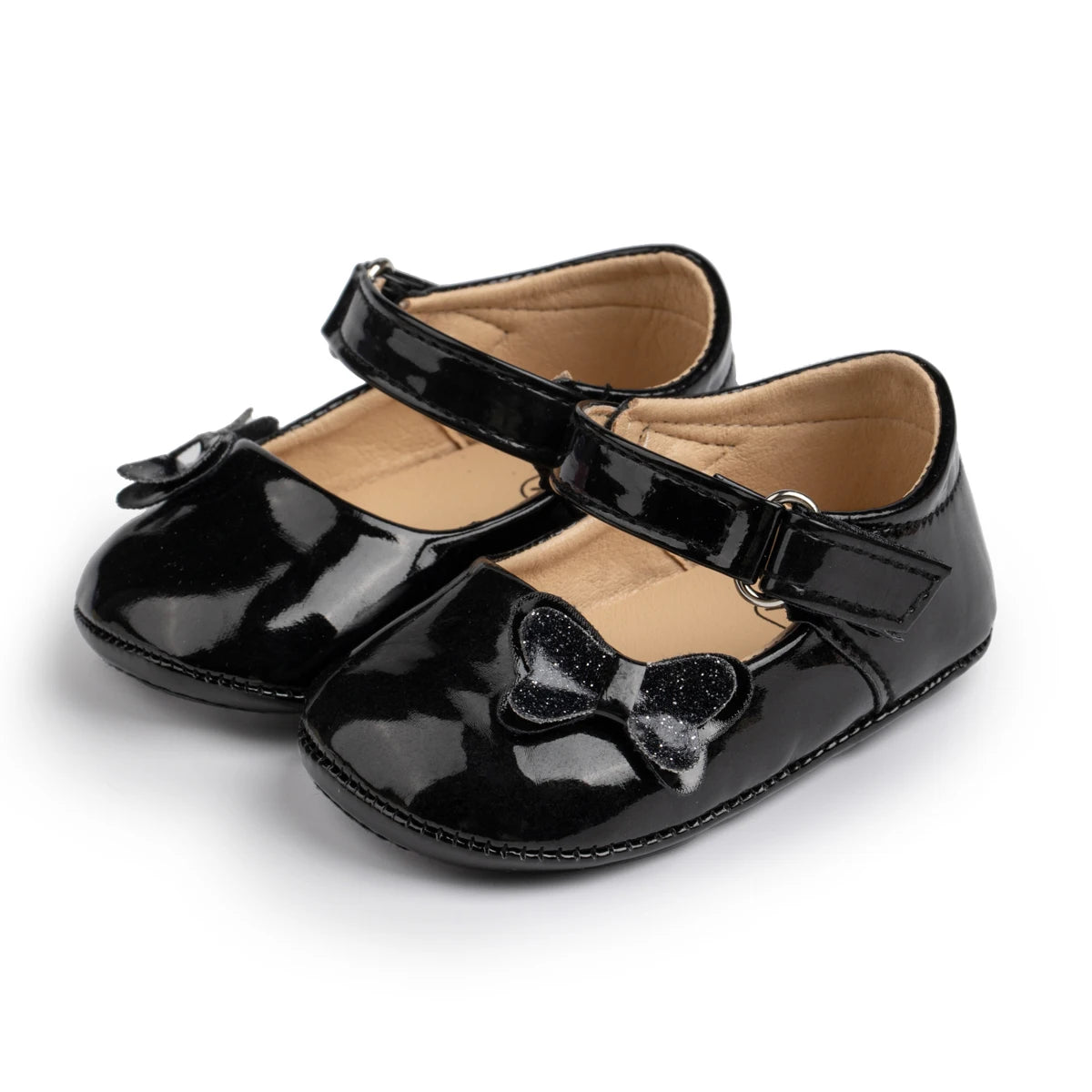 glossy black patent infant dress shoes with glitter butterfly detail and non-slip rubber soles for baby girls.