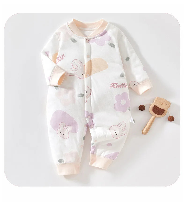 White baby romper with whimsical purple rabbit and flower print. Infant long sleeve one-piece with cream cuffs and "Rabbit" script design.