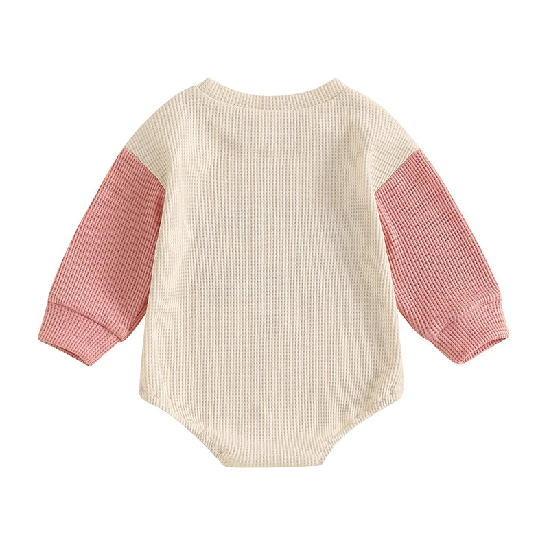 Back view of the Kidsely pink and cream colorblock baby girl waffle knit romper.