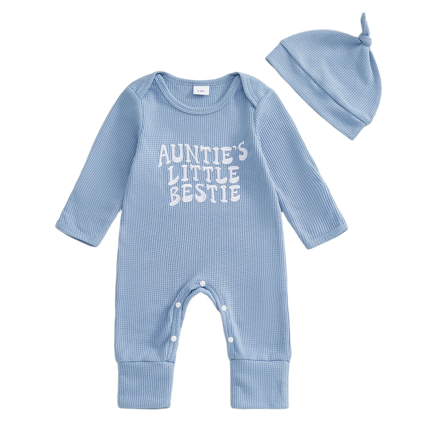 Light blue long-sleeve waffle knit baby romper featuring "Auntie's Little Bestie" in white text, paired with a matching blue baby hat.