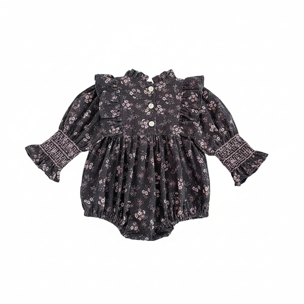 Back view of baby girl grey floral smocked long sleeve romper showing back neck button closure.