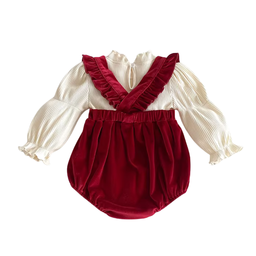 Back view of baby girl red velvet suspender straps crossed over cream ribbed long sleeve top.
