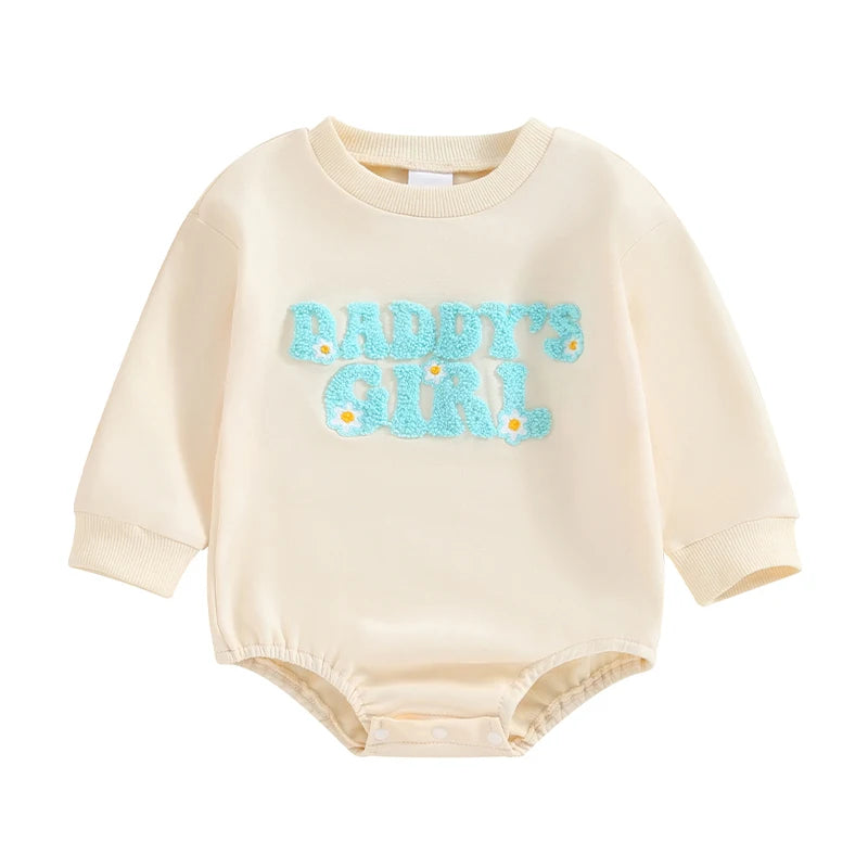 Beige Baby Girls "Daddy's Girl" long sleeve sweatshirt bubble romper with blue fuzzy letters and daisy details on a white background.