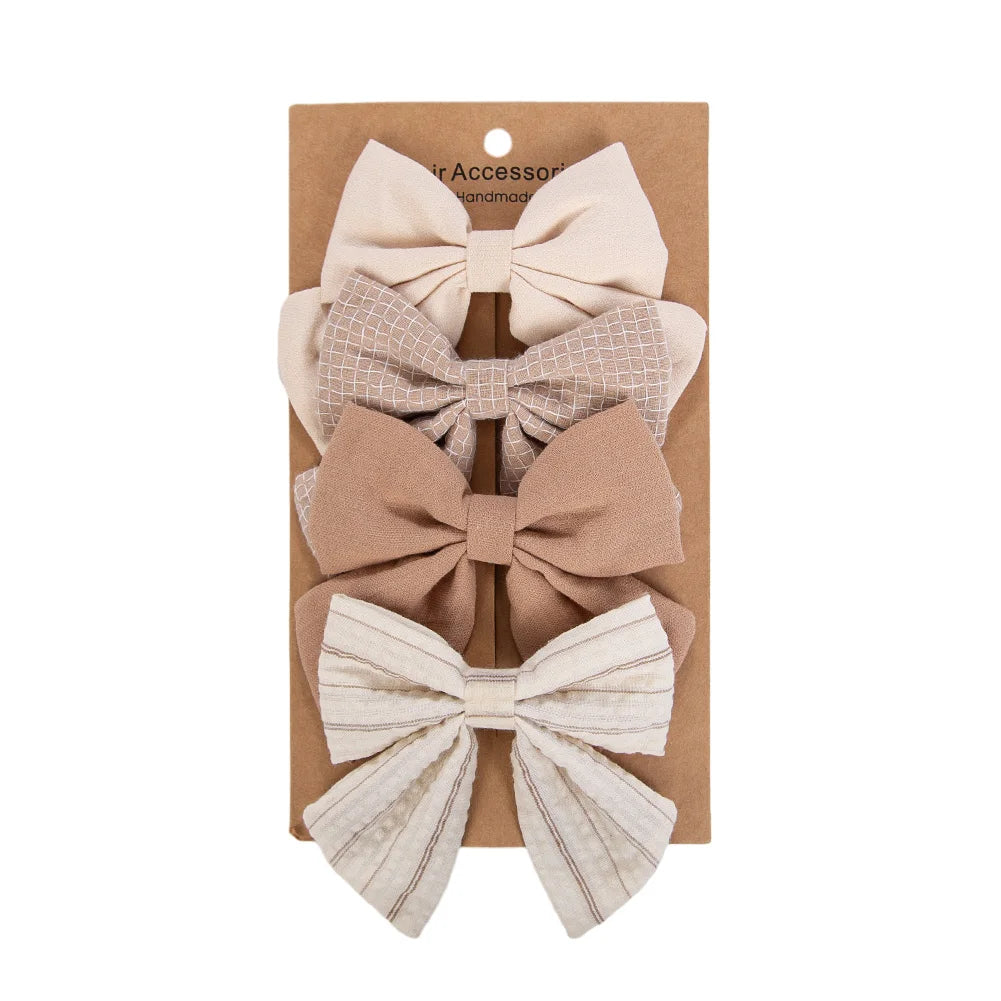 Kidsely Boutique Neutrals oversized hair bow set in cream, tan, taupe, and classic pinstripe linen fabric.