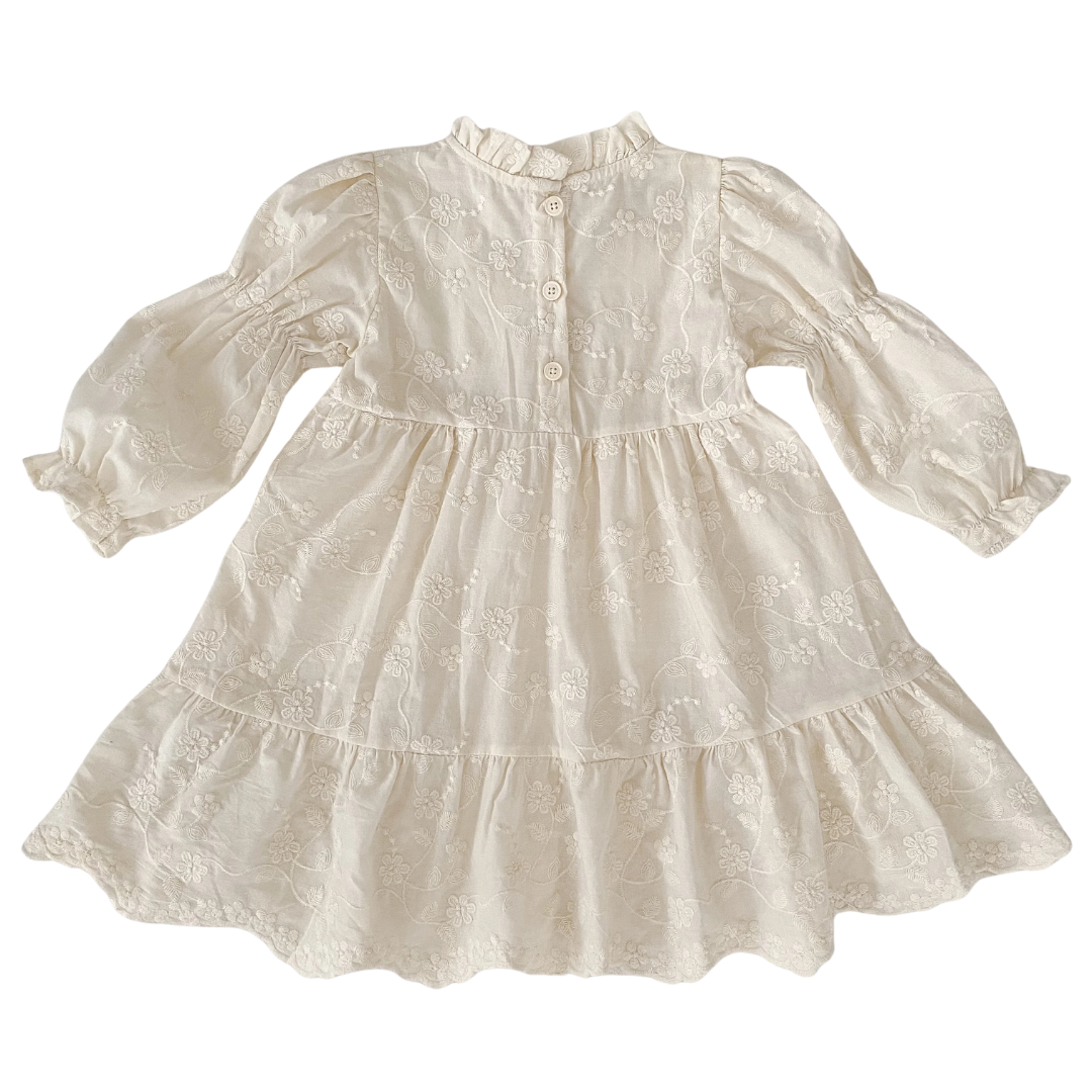 Back view of girls ivory floral embroidered cottagecore dress showing back button closures and high collar.