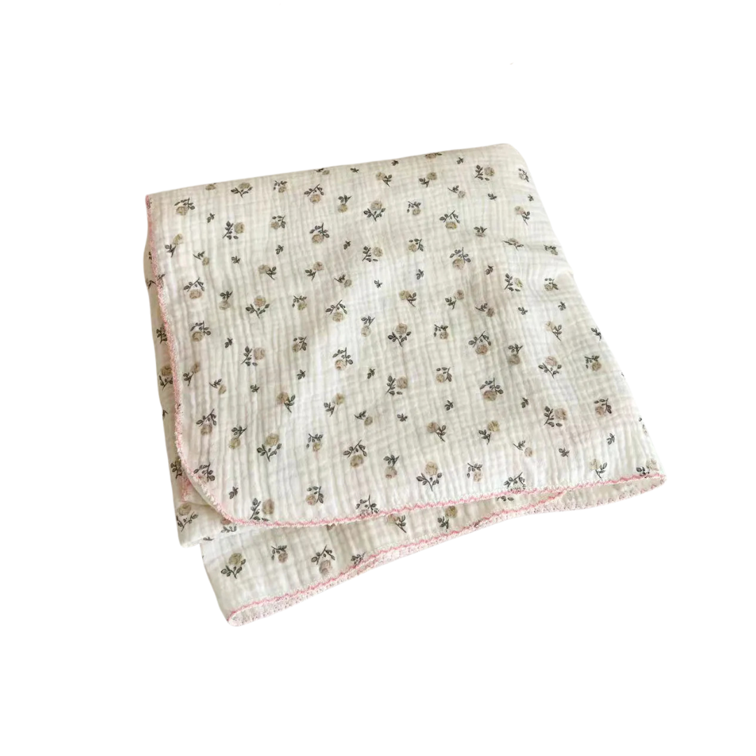 Folded gray and pink rose 2-layer cotton muslin swaddle blanket with pink scalloped trim on a pure white background.