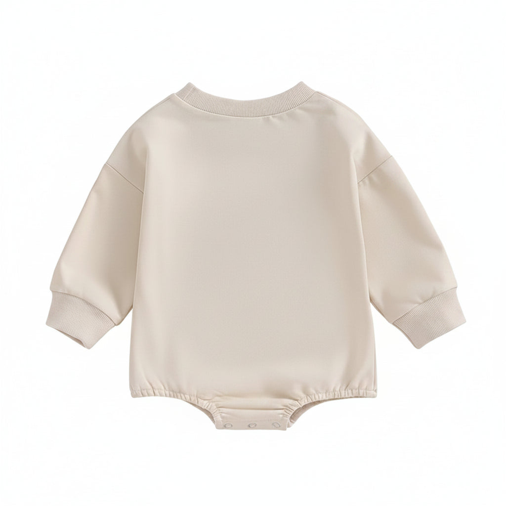 The plain back view of the neutral cream long-sleeve infant bubble romper layout.