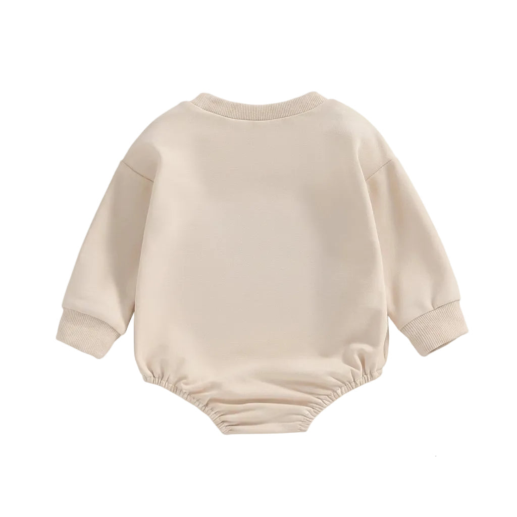 Back view of the plain neutral beige Little Bean long sleeve cotton baby bubble romper.