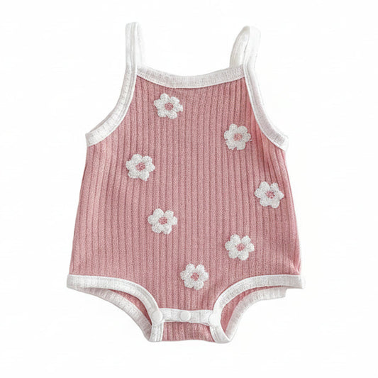 Pink ribbed sleeveless baby girl romper with white 3D flower towel embroidery on a clean white background.