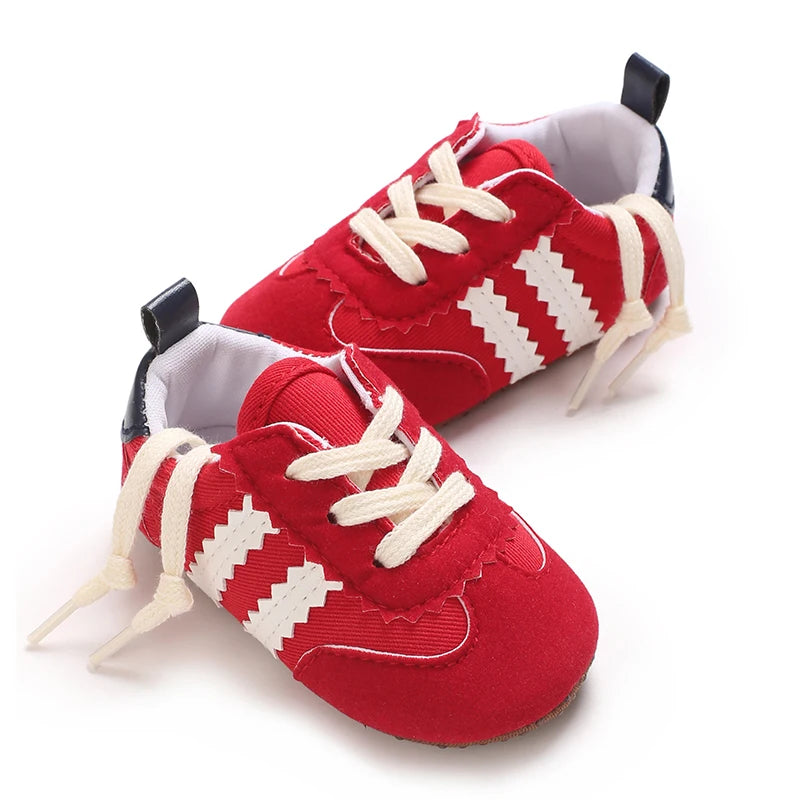 Vibrant red toddler casual sports shoes with breathable canvas upper and flexible safety sole.