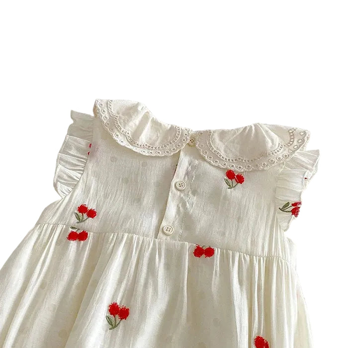 Back view of a baby girl romper showing the secure button-back closure and the ruffled lace Peter Pan collar.