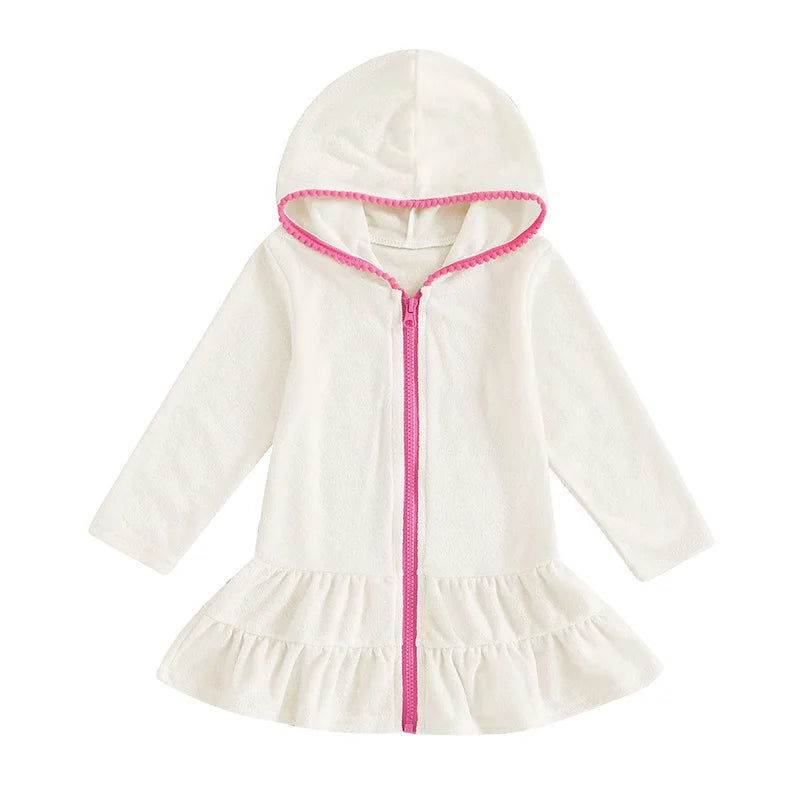 White long sleeve girls' hooded beach towel dress featuring a contrasting hot pink zipper and ruffle skirt.