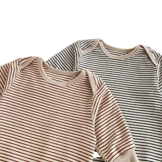 Close-up of the ribbed crew neckline on the neutral striped baby rompers in both Toasted Latte and Oat & Onyx colors.