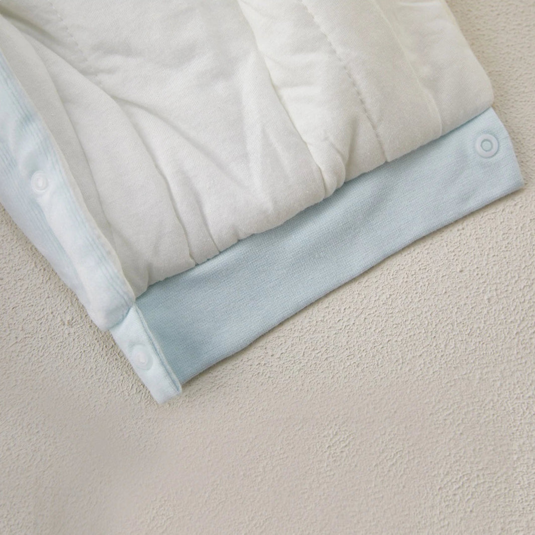 Detail view of bottom snap buttons on polyester baby romper.