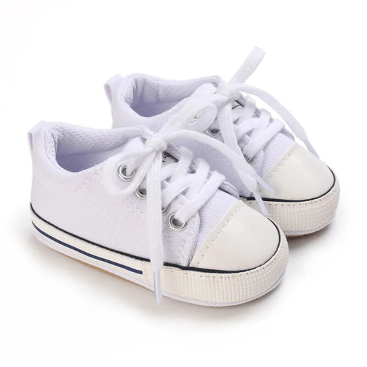 All-white infant canvas crib shoes, perfect for baptism, christening, or athletic stadium style.