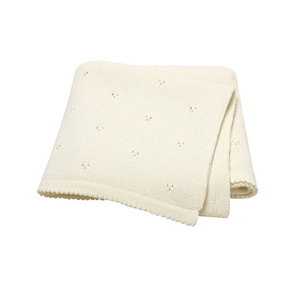 Cream-colored 100% cotton knit receiving blanket, hypoallergenic and breathable for nursery use.