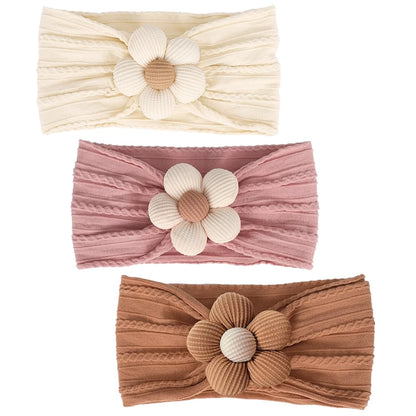 trio of baby hair accessories in buttercream, rosewood, and toasted pecan colors with textured flower centers