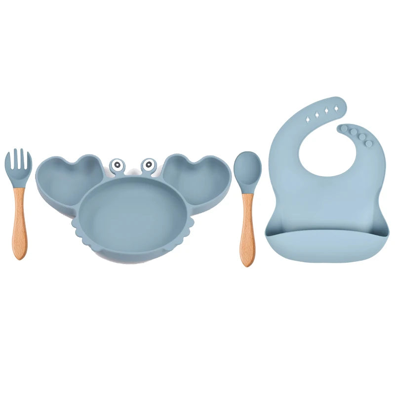 Blue baby feeding set with bowl, spoon, bib, and fork on a white background