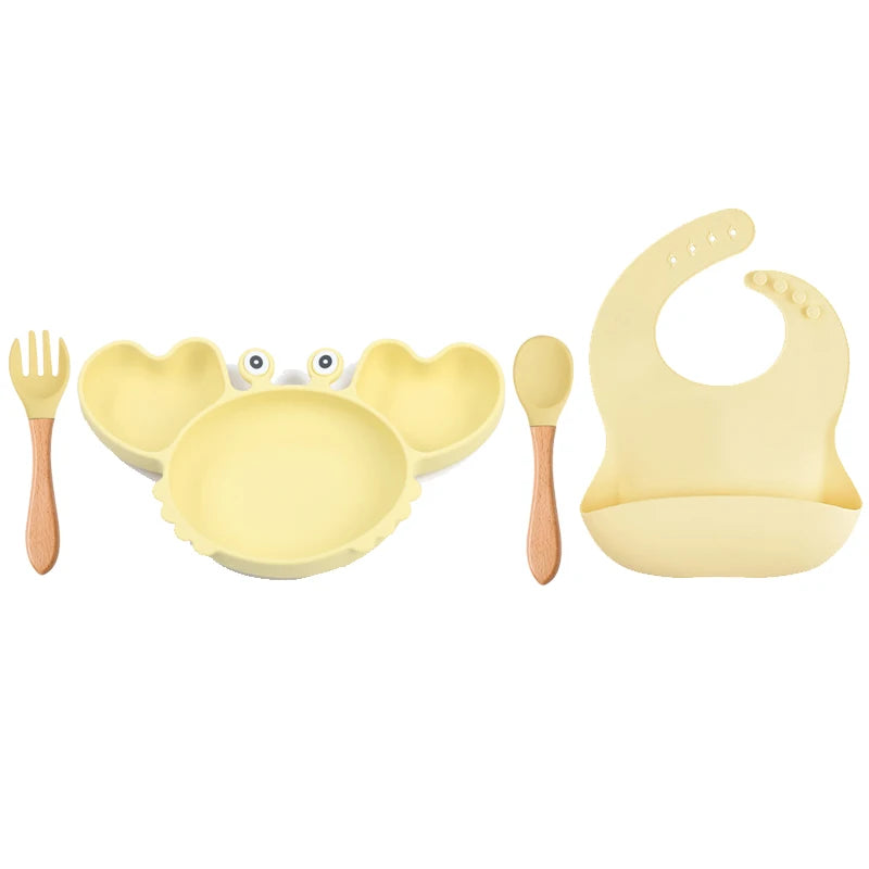 4-piece silicone baby feeding set including a crab-shaped divided plate, suction bowl, and silicone fork and spoon.