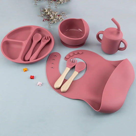 8-piece silicone baby feeding set including suction plate, bowl, adjustable bib, sippy cup, and utensils for baby led weaning.
