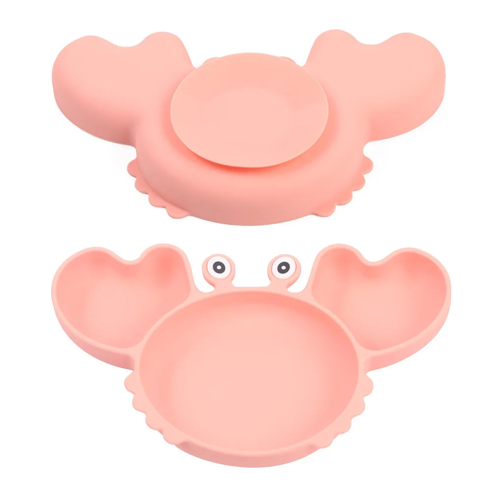 Two pink crab-shaped silicone dishes on a white background