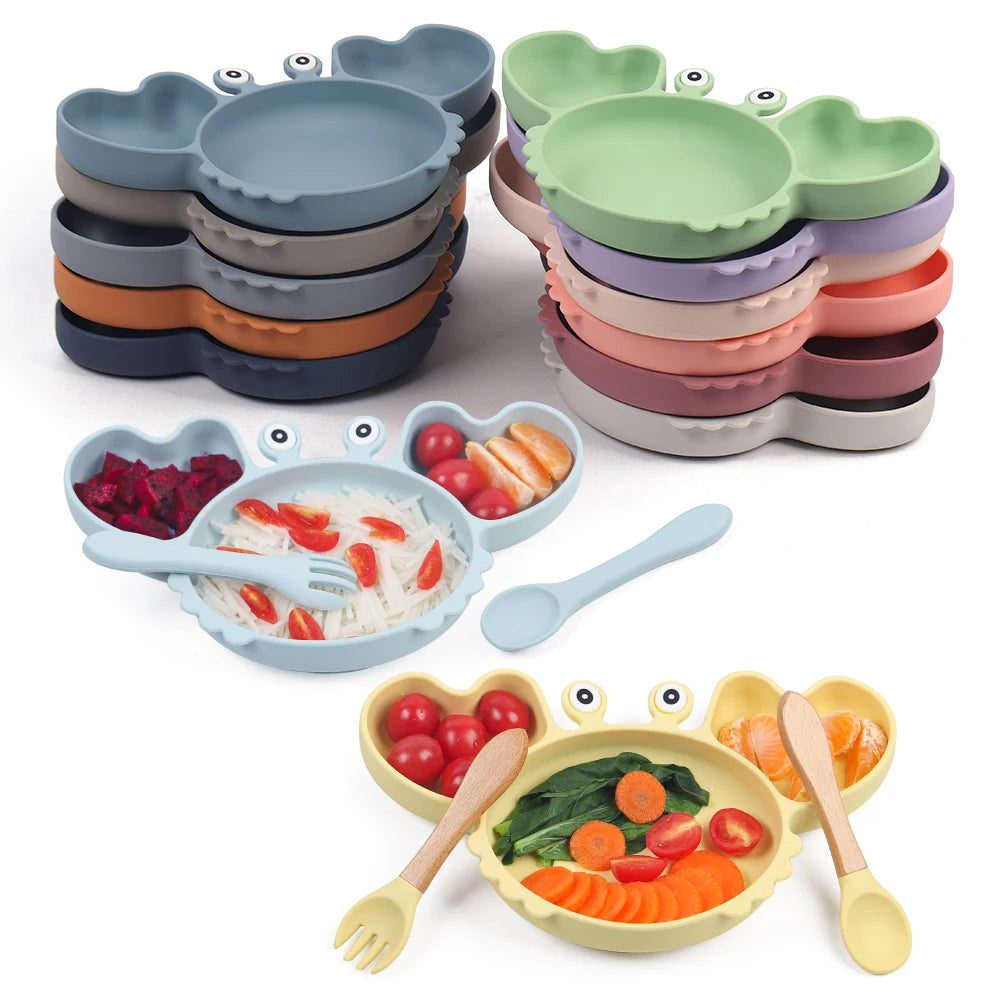 Set of colorful children's plates, bowls, and utensils on a white background
