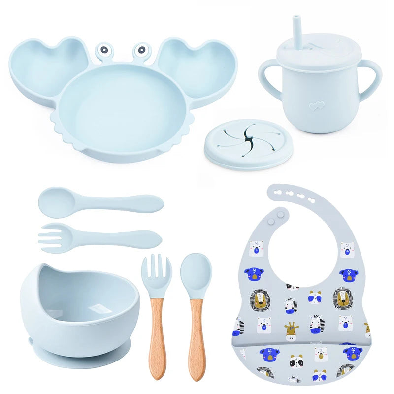 Collection of baby feeding utensils and accessories on a white background