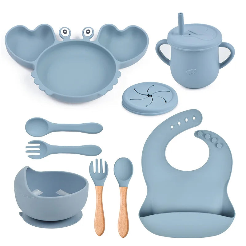Collection of blue baby utensils and accessories on a white background