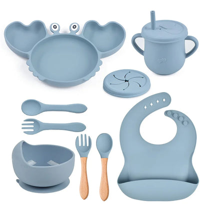 Collection of blue baby utensils and accessories on a white background