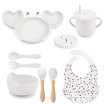 Collection of white baby utensils and accessories on a white background