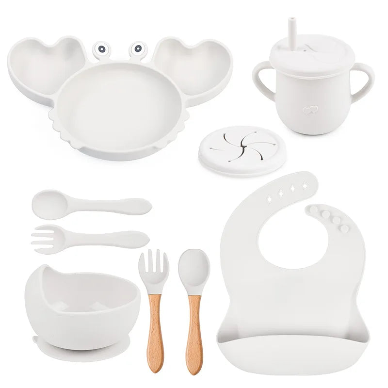 Collection of white baby utensils and accessories on a white background