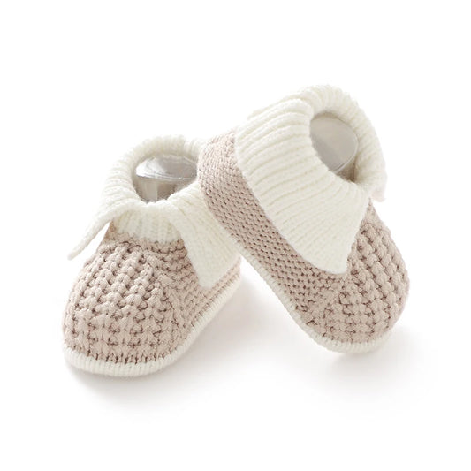 Pair of knit boutique style knit baby booties on a white background