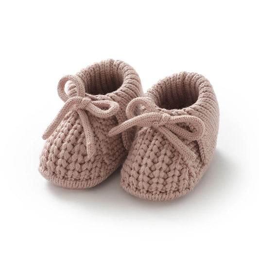 Artisan Style knit baby booties with adjustable front tie bow, anti-slip soft sole for infants 0-12 months.
