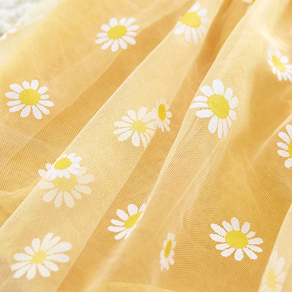 Close-up of yellow fabric with white daisy patterns