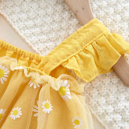Yellow dress with floral details on a textured surface