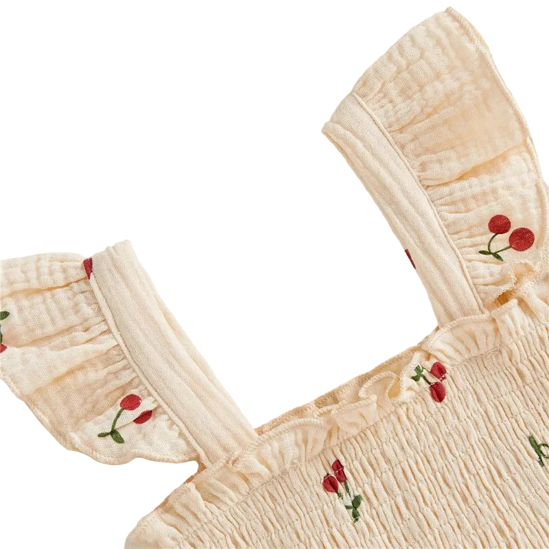 Beige dress with cherry print on a white background