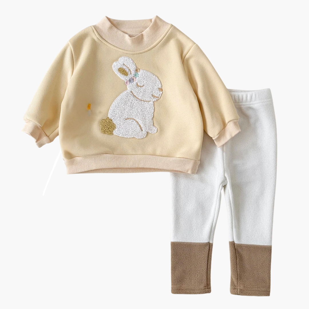 Children's outfit with beige sweater and white pants featuring a rabbit design on a white background