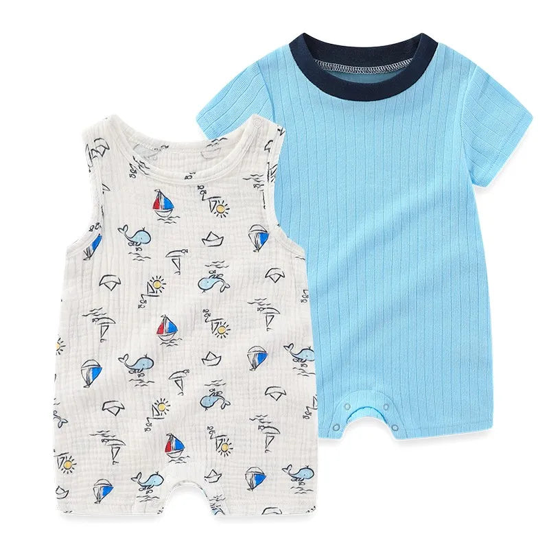 Baby boy nautical romper set featuring a light blue short-sleeve shortall with a navy collar and a white sleeveless romper with hand-drawn sailboat and whale sketches.