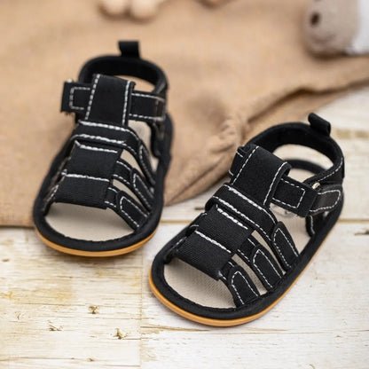 Classic black baby boy first walker sandals with anti-slip rubber outsole, designed for safe indoor and outdoor summer play for ages 0 to 18 months.