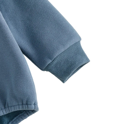 Close-up shot showing the high-quality ribbed wrist cuff and soft fleece fabric texture of the blue baby romper.