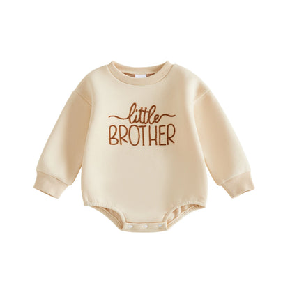 Cream colored fleece baby boy crewneck sweatshirt romper featuring brown embroidered Little Brother text.