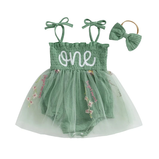 Premium sage green baby girl first birthday romper set with white "one" embroidery, floral tulle tutu skirt, and matching bow headband on a clean white background.