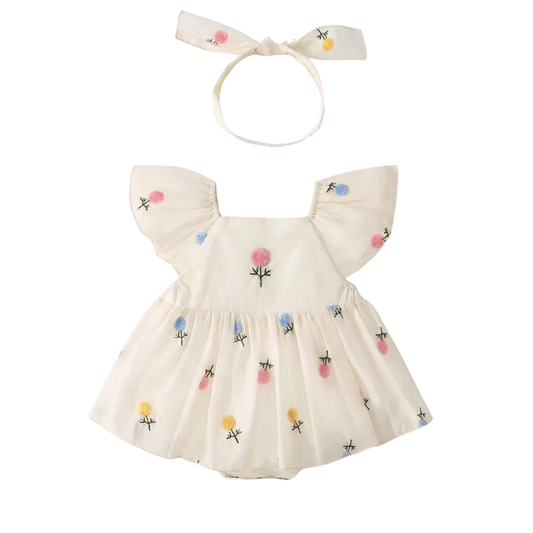White 100% cotton baby girl romper dress with pastel floral embroidery on the chest, flutter sleeves, and matching floral bow headband. 3M-24M boutique summer outfit.