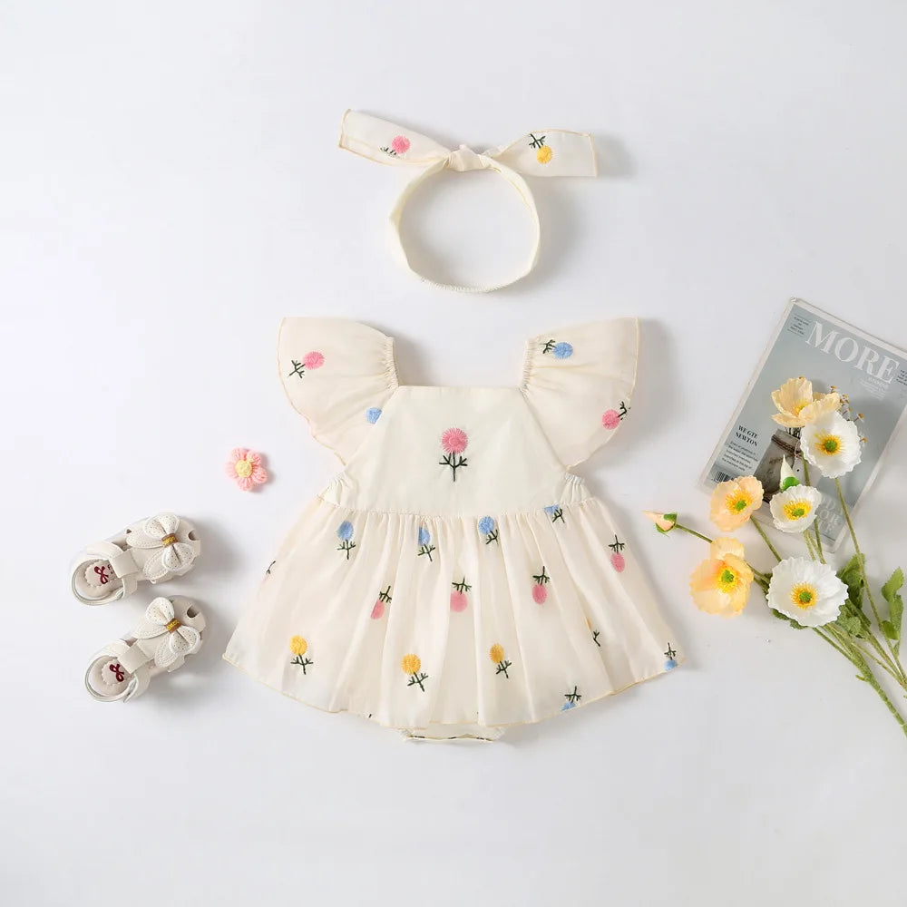 Two-piece baby girl summer clothing set including a white floral embroidered romper dress and a coordinating pink floral print knotted headband.