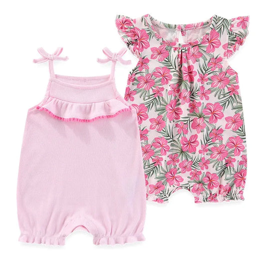 Baby girl tropical romper set featuring a pink hibiscus flower print and a solid pink ribbed romper with tie-shoulder bows and ruffled chest detail.