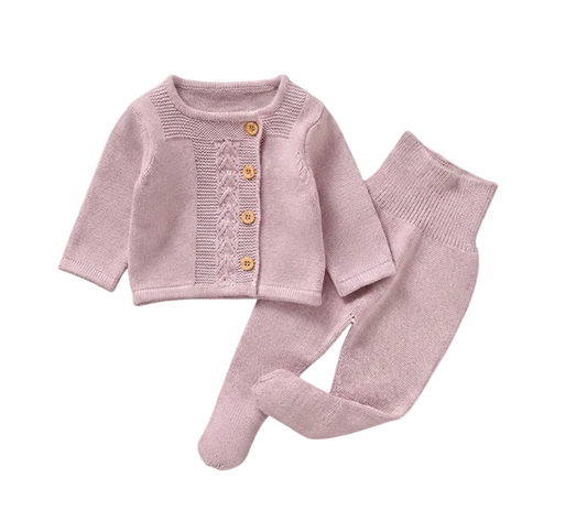 Pink baby outfit with cardigan and pants on a white background