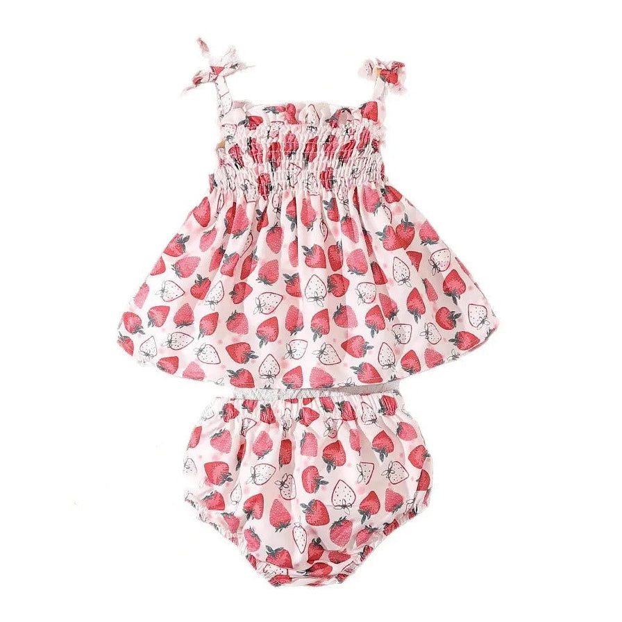 Baby girl's romper with strawberry pattern on a white background