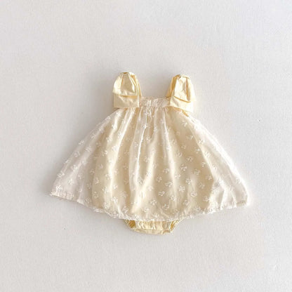 Yellow Baby dress with bow straps on a white background