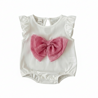 White baby girl romper featuring flutter ruffle sleeves and a large pink decorative bow on the front, isolated on a white background.